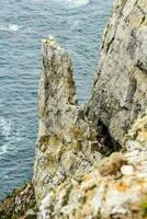 the edge of a cliff overlooking the ocean photo