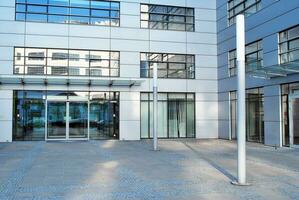 Modern office building in the city with windows and  steel and aluminum panels wall. photo