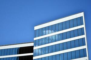 Urban abstract - windowed wall of office building. Detail shot of modern business building in city. photo