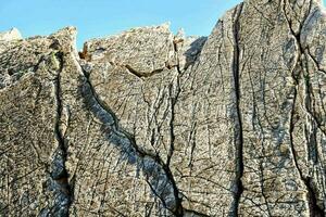 a rock wall with cracks photo