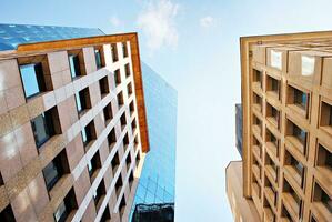 Structural glass wall reflecting blue sky. Abstract modern architecture fragment photo