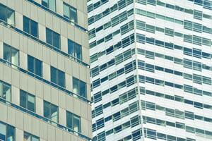 Structural glass wall reflecting blue sky. Abstract modern architecture fragment photo