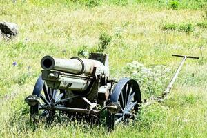 an old cannon sits in the middle of a field photo