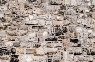 a stone wall with many different types of stones photo