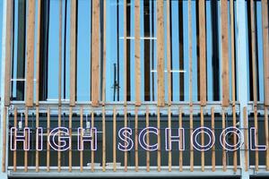 Structural glass wall reflecting blue sky. Abstract modern architecture fragment. photo