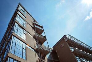 Modern apartment building in sunny day. Exterior, residential house facade photo