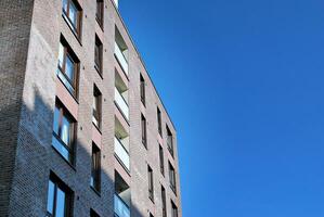 Modern apartment building in sunny day. Exterior, residential house facade. photo