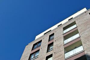 Modern apartment building in sunny day. Exterior, residential house facade. photo