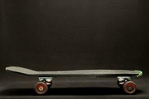 a skateboard with wheels on a black background photo
