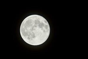 the full moon is seen in the dark sky photo