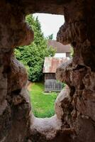 a view through a window in an old stone building photo