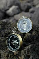 two compasses on a rock photo