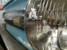 Old retro car headlight close view photo, automobile background photo