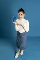 Portrait of beautiful asian girl posing on blue background photo