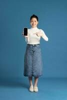 Image of beautiful Asian woman posing on blue background photo