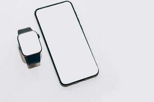 A black technological smart watch has a white screen for a place for text with a phone. photo