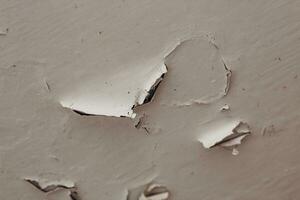 Cracked old plaster on the ceiling close-up. photo