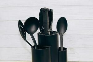 Kitchen tools plastic for multicooker on a wooden table in a dish organizer. photo