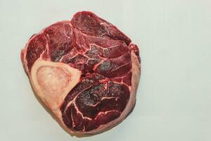 Fresh piece of meat big beef steak on the bone ossobuco photo