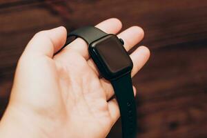 Black technological smart watch in hand photo