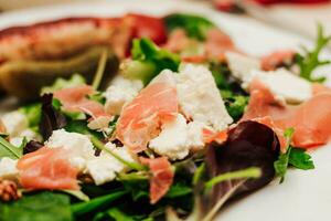 Salad with feta cheese with arugula and fried sausage. photo