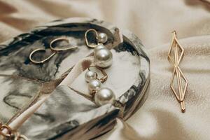 Women's jewelry, gold chain, trendy jewelry on a silk background photo