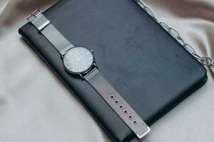 Clock and work notepad, business and time management concept. photo