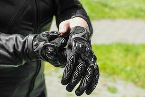 The girl wears protective moto gloves, safe equipment photo
