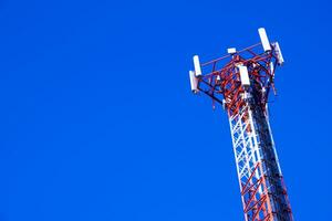 a cell phone tower with a clear blue sky photo