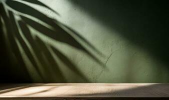 Table empty against background of dark green plaster wall. composition featuring light reflections photo