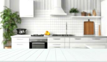 Blurred view of modern kitchen with white furniture with wooden table photo