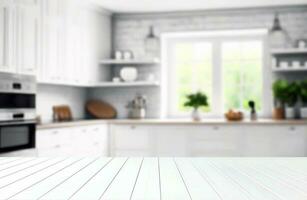 Blurred view of modern kitchen with white furniture with wooden table photo