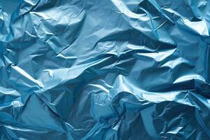 blue plastic wrap overlay backdrop. crumpled and draped textured cellophane material photo