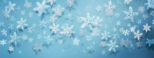 falling snowflakes and ice flakes on a light blue winter backdrop photo