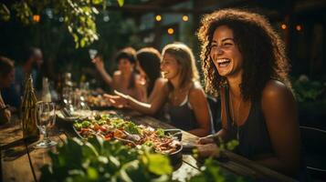 Joyful Woman Laughing at Outdoor Sunset Gathering with Friends photo