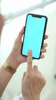 Hand holding mobile phone, smartphone in hand, closeup of hand holding phone video