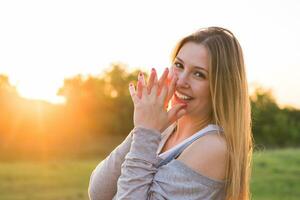 Beauty Sunshine Girl Portrait. Happy Woman Smiling. Sunny Summer Day under the Hot Sun. photo