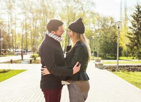 Happy pregnant woman and her husband in the park photo