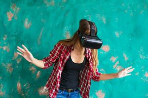 Smile happy woman getting experience using VR-headset glasses of virtual reality much gesticulating hands photo