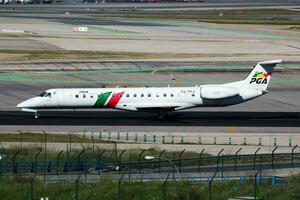 Madrid, Spain, 2020 - PGA Portugalia Airlines passenger plane at airport. Schedule flight travel. Aviation and aircraft. Air transport. Global international transportation. Fly and flying. photo