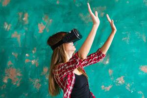 Smile happy woman getting experience using VR-headset glasses of virtual reality much gesticulating hands photo