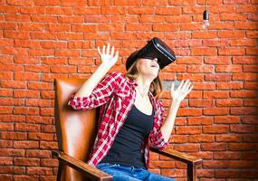 Smile happy woman getting experience using VR-headset glasses of virtual reality much gesticulating hands photo