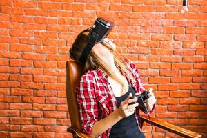 technology, virtual reality, entertainment and people concept - woman with vr headset playing game. photo