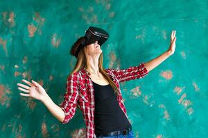 Smile happy woman getting experience using VR-headset glasses of virtual reality much gesticulating hands photo