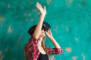 Smile happy woman getting experience using VR-headset glasses of virtual reality much gesticulating hands photo