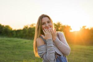 Beauty Sunshine Girl Portrait. Happy Woman Smiling. Sunny Summer Day under the Hot Sun. photo