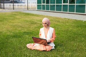 Young Muslim Girl using laptop photo