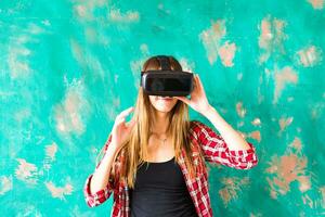 Smile happy woman getting experience using VR-headset glasses of virtual reality much gesticulating hands photo