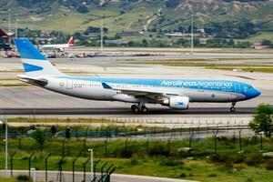 Madrid, Spain, 2016 - Aerolineas Argentinas passenger plane at airport. Schedule flight travel. Aviation and aircraft. Air transport. Global international transportation. Fly and flying. photo