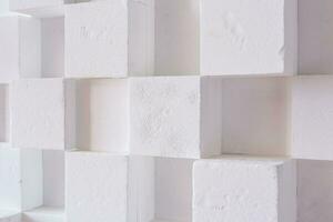 abstact modern architecture background with white cubes on the wall photo